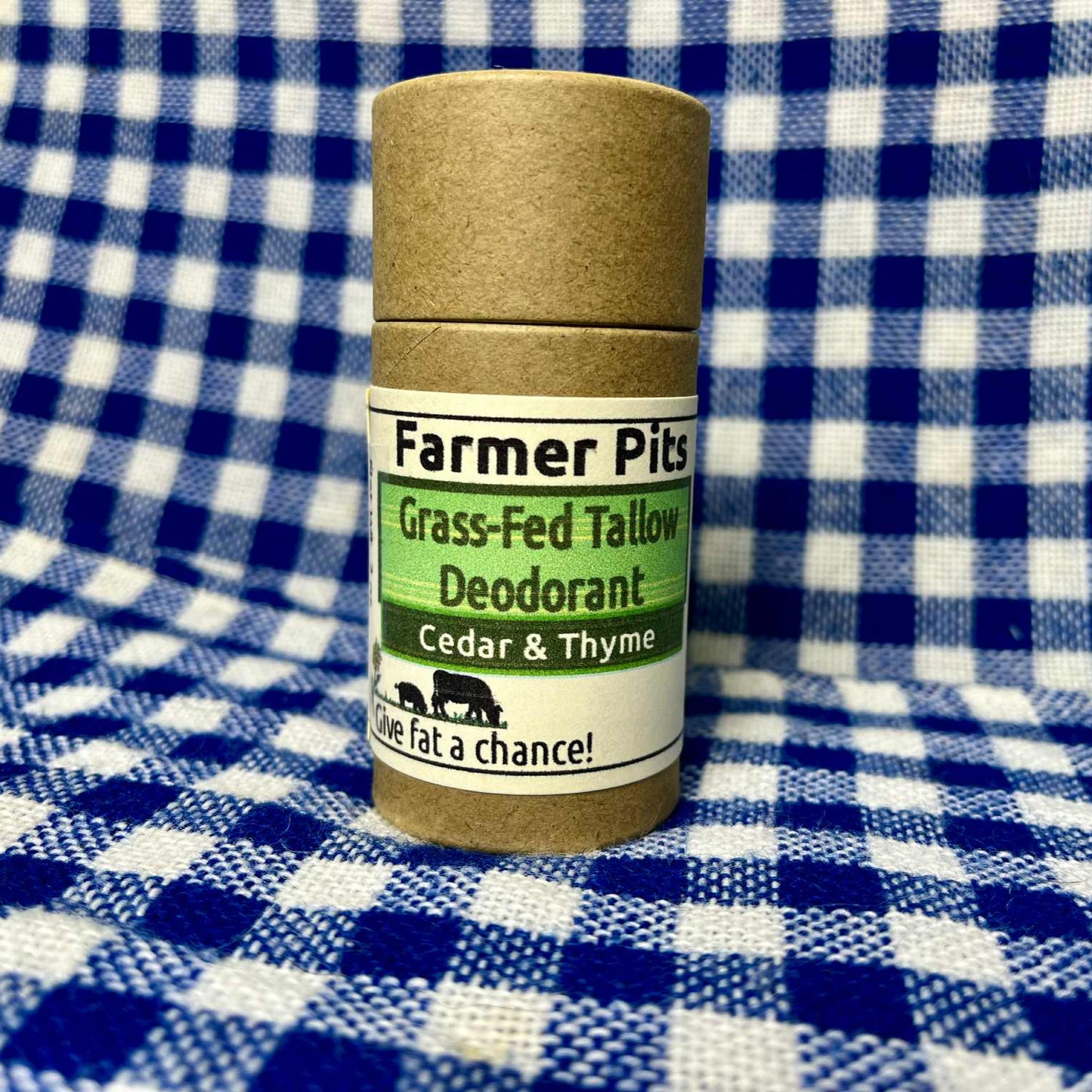 Deodorant stick labeled 'Farmer Pits' on a blue and white checkered background