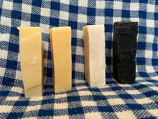 four small blocks of tallow and lard soap in different colors