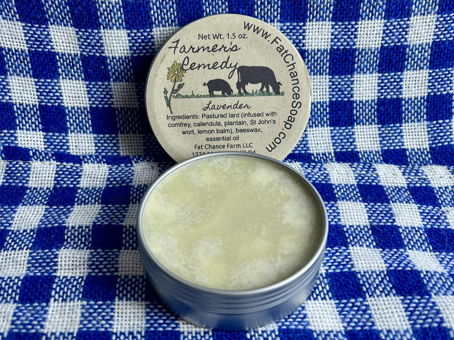 an open tin of herbal lard salve