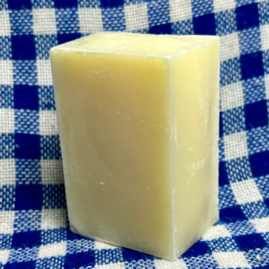 Bar of soap on a blue and white checkered fabric background