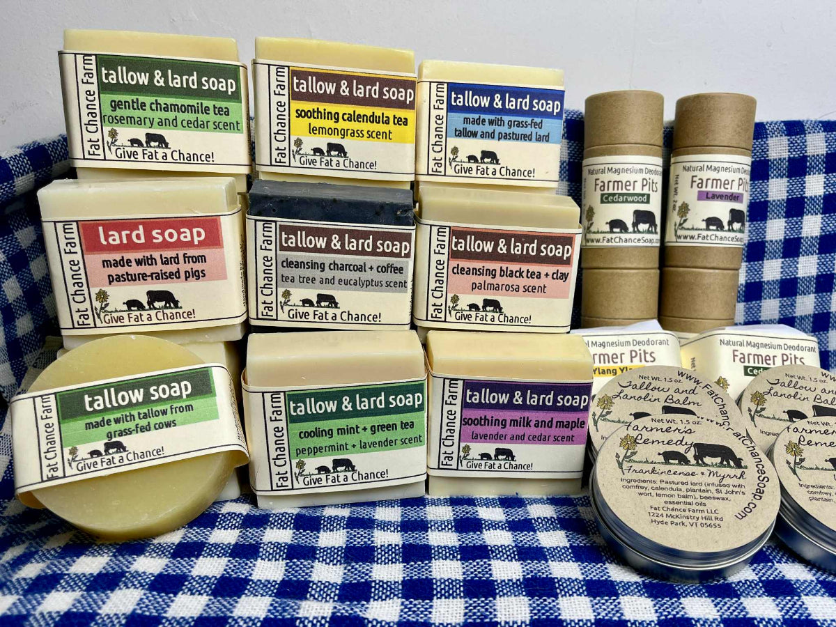 Collection of tallow and lard soaps on a blue and white checkered tablecloth