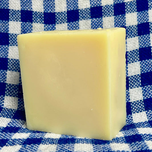 Bar of soap on a blue and white checkered fabric background