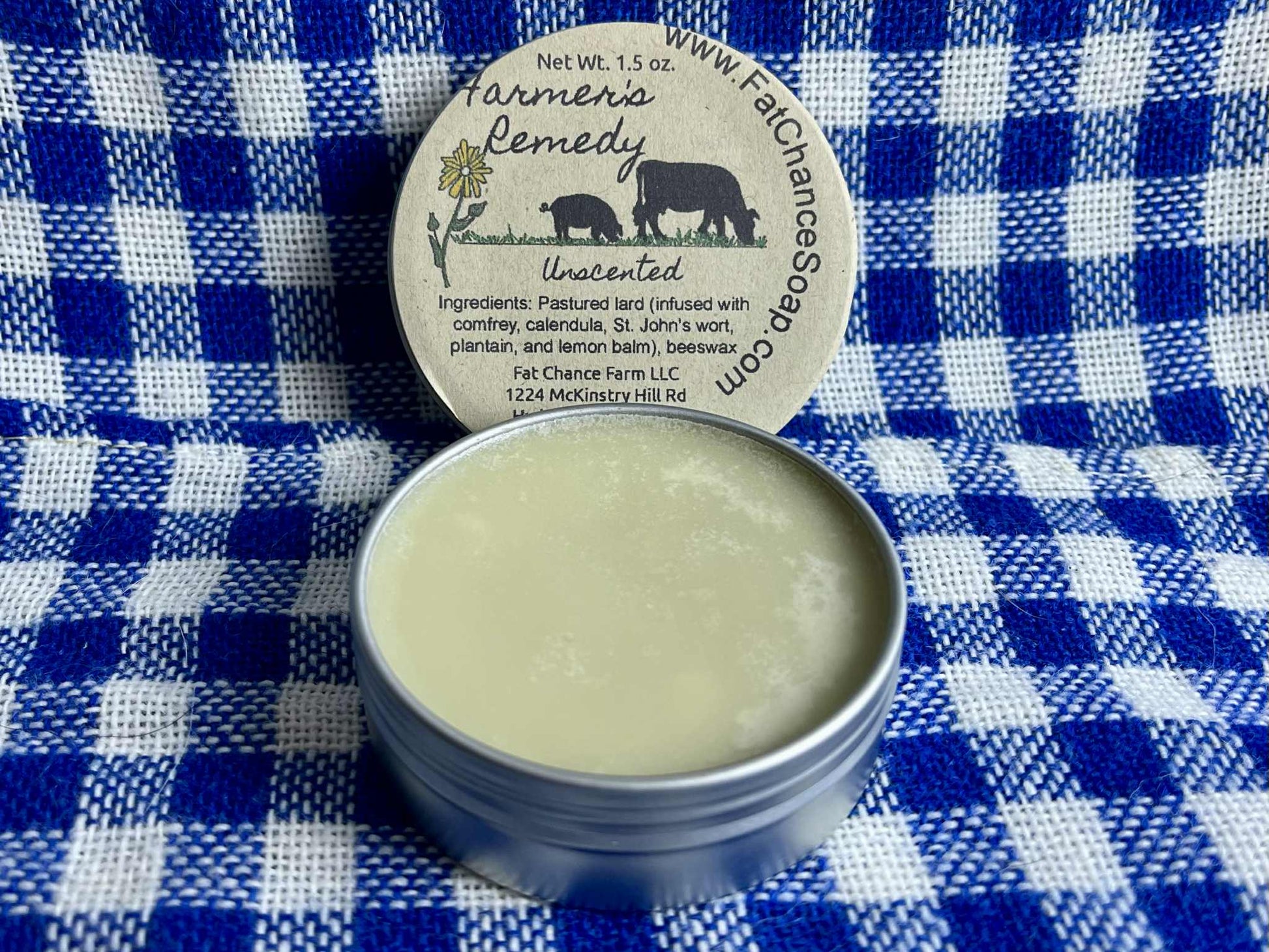 an open tin of herbal lard salve